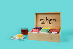 Two Leaves and a Bud green tea sachet close-up showing full-leaf infusion