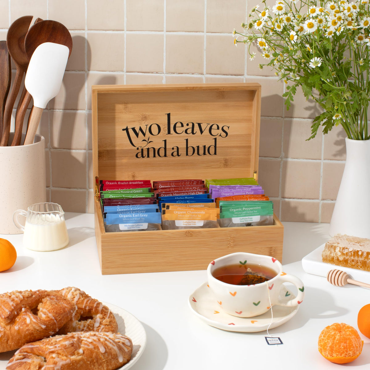 Two Leaves and a Bud green tea sachets visible inside the gift box