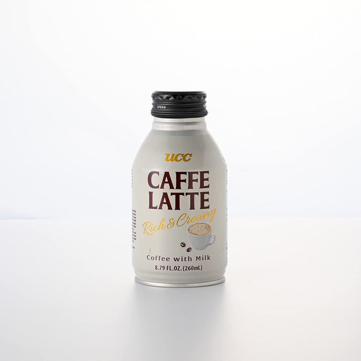 UCC Caffe Latte being poured into a mug, showcasing creamy texture.