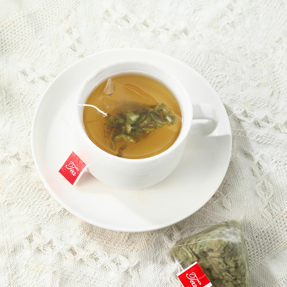 ULTHMOK steeping tea bag in cup demonstrates calm, soothing aroma.