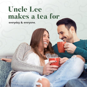 Uncle Lee's Organic White Tea brewed in a glass cup releasing pale gold aroma.