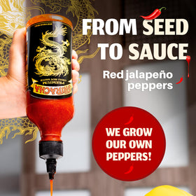 Dragon Sriracha bottle close-up with red jalapeños and label.