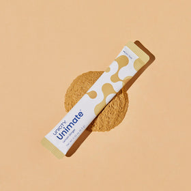 Single Unimate lemon ginger packet in hand, easy on-the-go energy