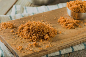 Measuring spoon with Unpretentious dark brown sugar for precise baking.