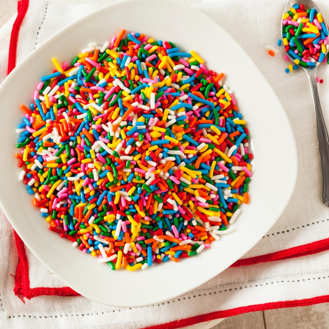 Unpretentious Rainbow Sprinkles topping on cupcakes for a festive look
