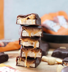 UNREAL bars with visible peanut bits and glossy chocolate coating