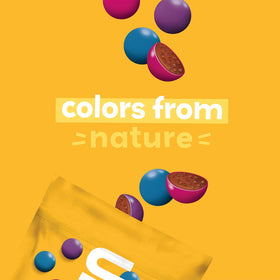 UNREAL dark chocolate quinoa gems snack serve close-up highlighting crispy quinoa crunch.