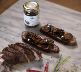 Urbani Truffles carpaccio slices on plate showcase premium Italian flavor.