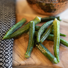 US Snacks Dried Okra Chips sea salt crisp closeup, lower calorie crunch ideal for snacking.
