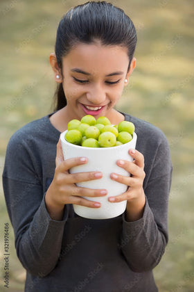US Wellness Naturals Amalaki powder poured into a cup for tea or yogurt.