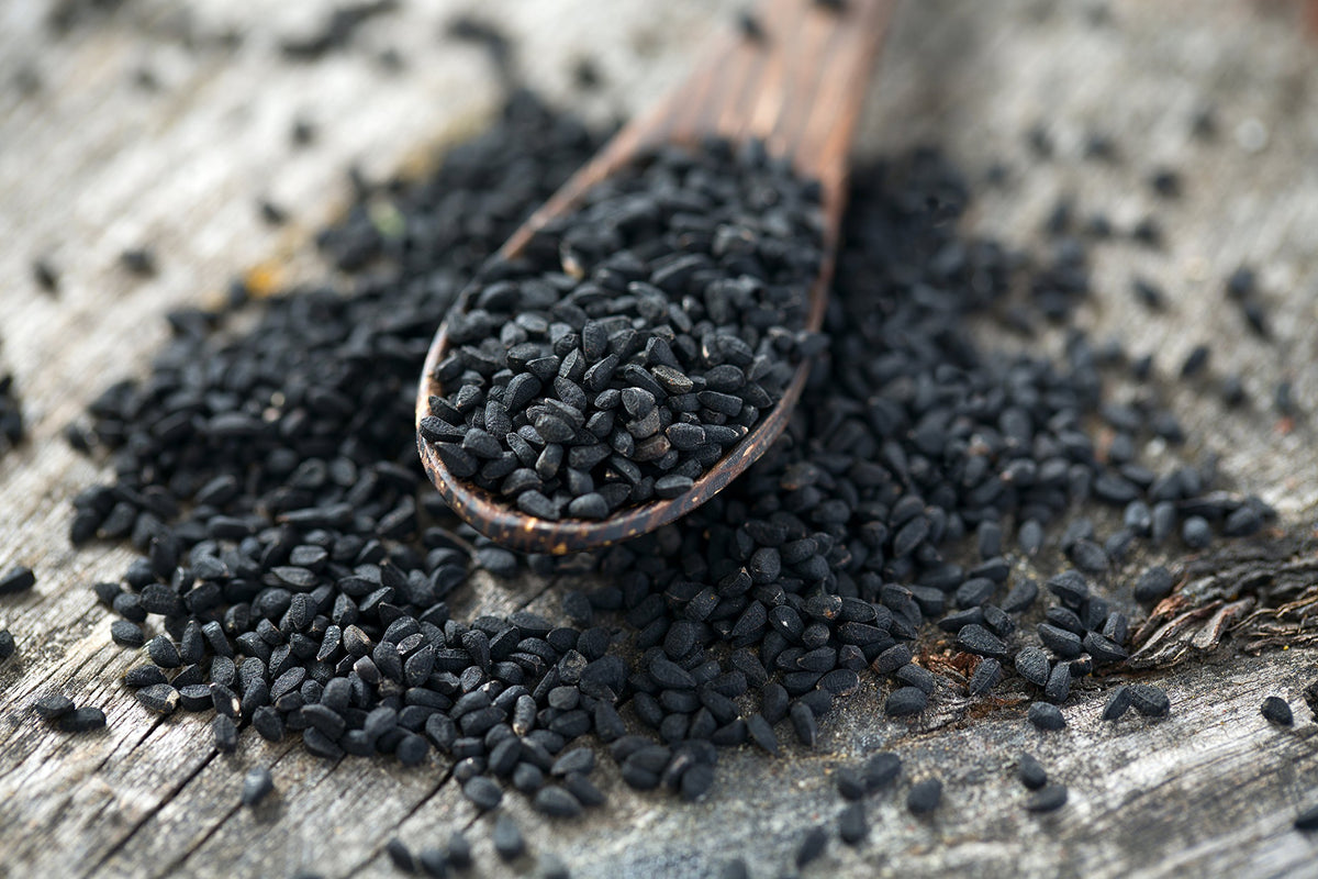 US Wellness Naturals black cumin seeds close-up showing rich texture for flavoring.