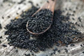 US Wellness Naturals black cumin seeds close-up showing rich texture for flavoring.