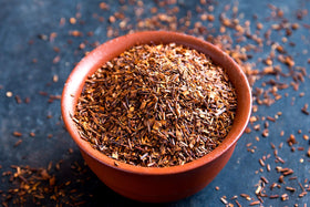 Brewing Honeybush tea in a mug for a rich amber brew