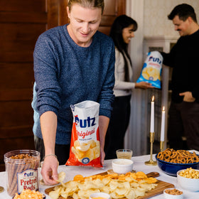 Utz Ripples Sour Cream & Onion bag close-up highlighting ridged texture and flavor.