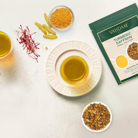 VAHDAM Herbal Tea ingredients featuring cardamom, almonds, pistachios, and ginger