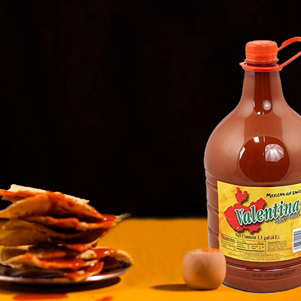 Valentina chips dip sauce in action, suggesting tangy kick for snacks.