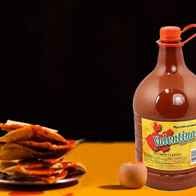 Valentina chips dip sauce in action, suggesting tangy kick for snacks.