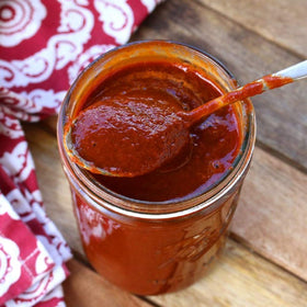 Valentina tacos dipping shot shows vibrant sauce enhancing street-food style meals.