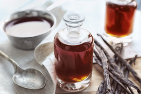 Vanilla Bean Kings bottle being poured highlights rich flavor for desserts.