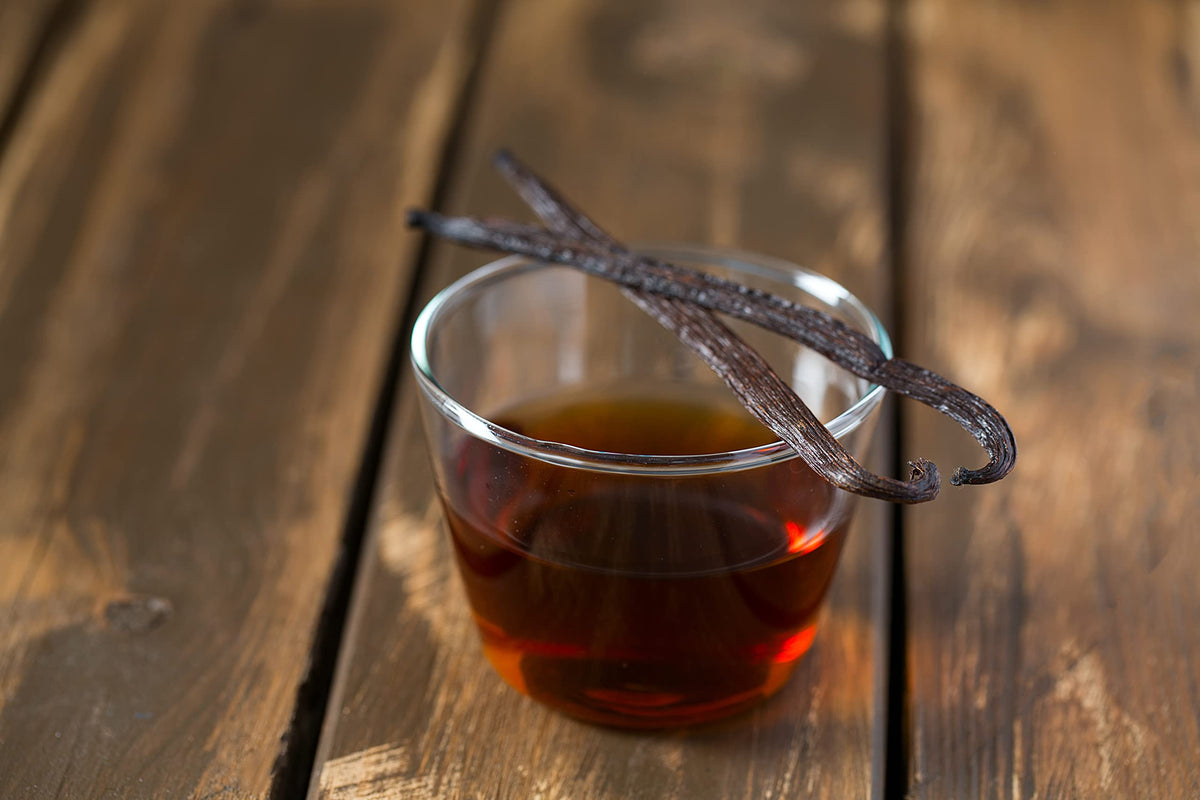 Pouring Vanilla Bean Kings vanilla extract into a bowl for recipes.