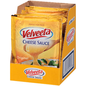 Open Velveeta pouch being squeezed into a bowl.
