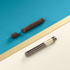 Venchi chocolate cigar shows creamy hazelnut filling, ideal for sharing after meals