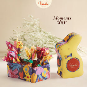 Venchi spring collection artwork by Teresa Rego, vivid design on the tin.
