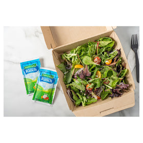 Hidden Valley Ranch dressing with creamy texture poured over a salad.