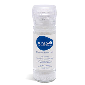 Vera Salt coarse spring salt crystals inside a glass bottle for fresh table grinding.