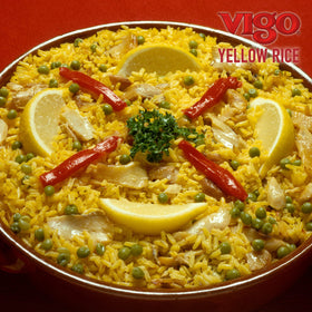 Vigo saffron yellow rice paired with grilled meat creates a hearty meal.