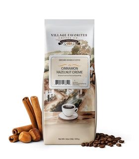 Village Favorites Cinnamon Hazelnut Creme ground coffee in a 1lb bag for rich flavor.