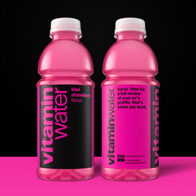 Vitaminwater Focus Kiwi Strawberry being poured into a glass emphasizes refreshing flavor and aroma.
