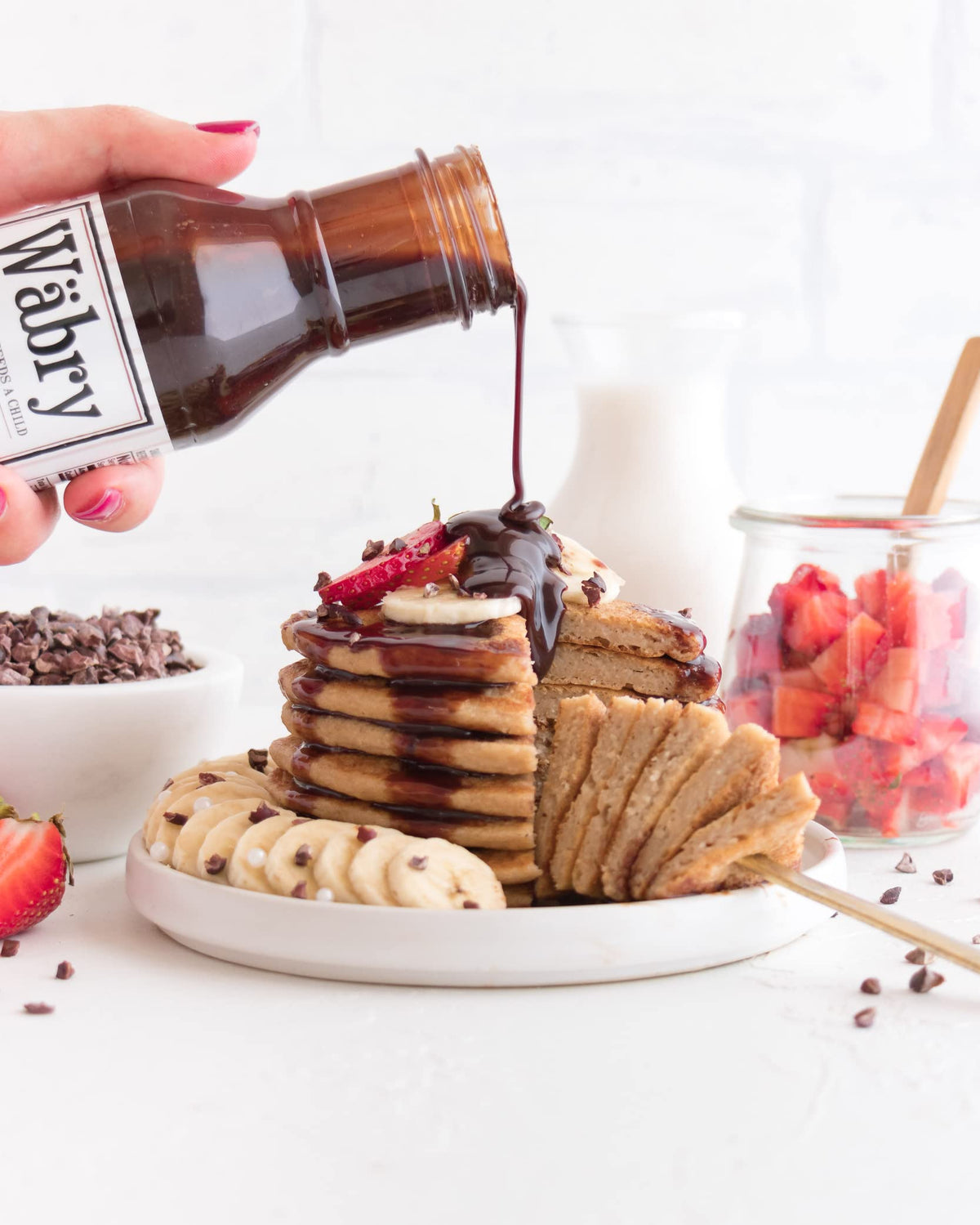 Wäbry chocolate hazelnut drizzle on ice cream invites creamy texture.