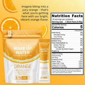 Wake Up Water orange glass – refreshing, sugar-free energy for your day.