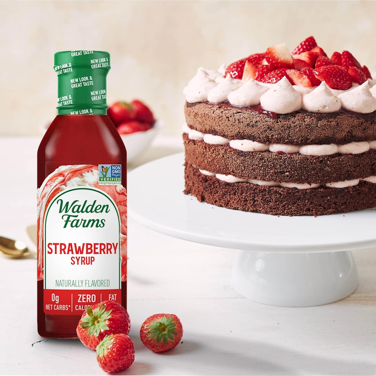 Walden Farms Strawberry Syrup in a glass with fresh berries