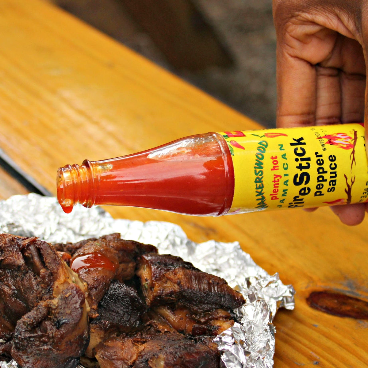 Walkerswood Hot JonKanoo Pepper Sauce bottle, versatile spice for marinades and sauces.
