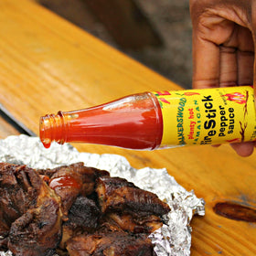 Walkerswood Hot JonKanoo Pepper Sauce bottle, versatile spice for marinades and sauces.