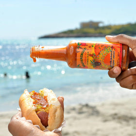 Walkerswood Zesty Caribbean One Stop Sauce bottle, convenient flavor booster for meals.
