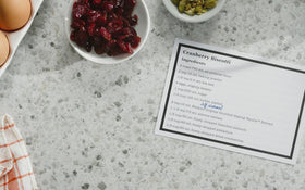 Watkins bottle on kitchen counter suggests everyday pantry staple for seasoned recipes.