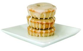 Watkins cinnamon being sprinkled into batter for flavorful outcomes.