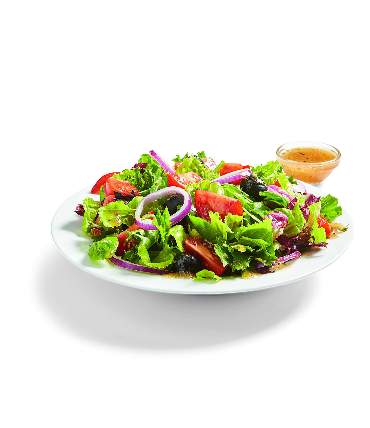 Pouring dressing from Watkins Organic Italian Dressing Mix into a bowl.