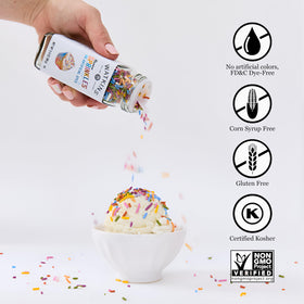 Pouring Watkins Rainbow Sprinkles over cupcakes for festive flair