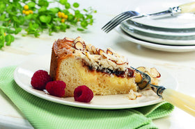Natural ingredients scene with Watkins Raspberry Extract and raspberries.