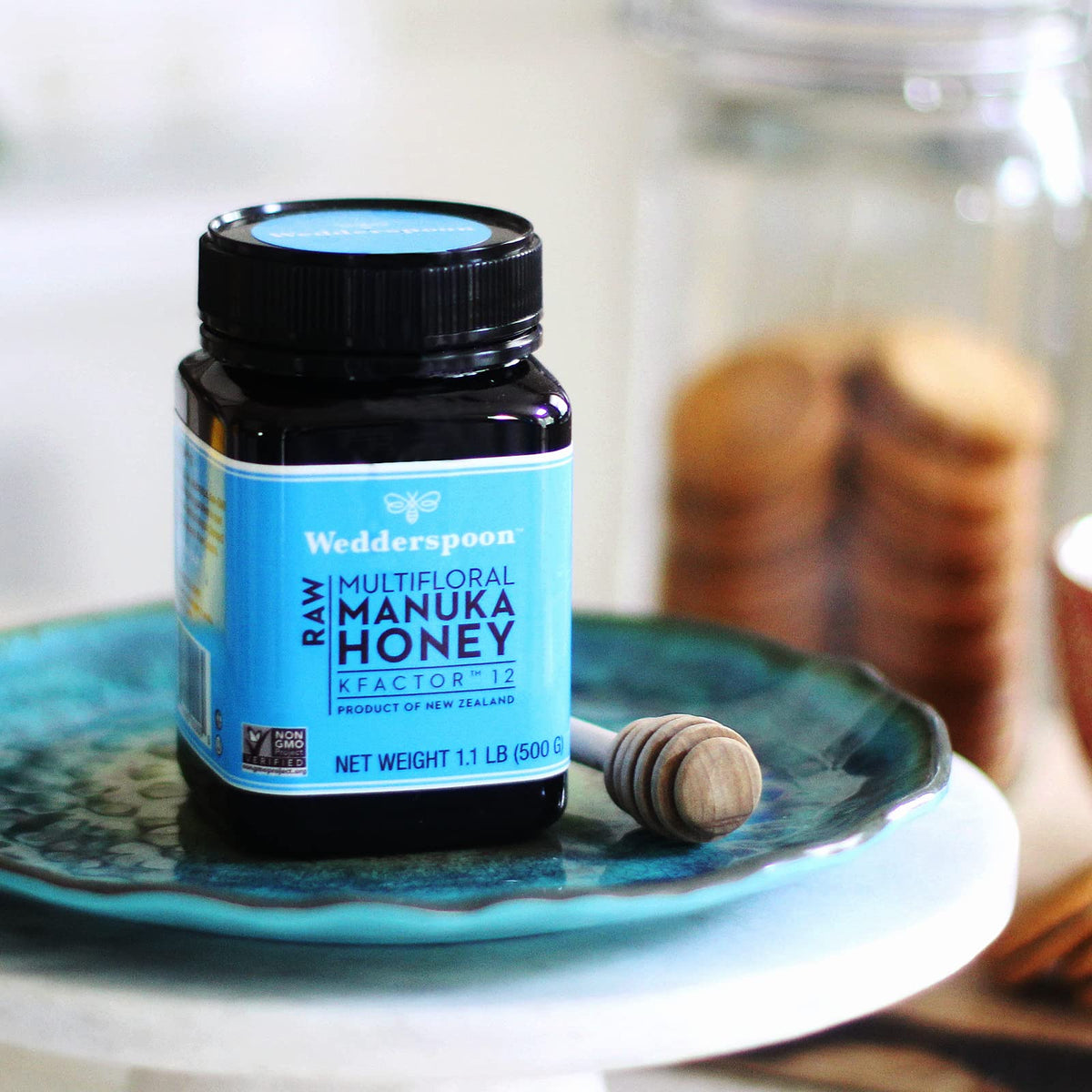 Wedderspoon Manuka honey in a sunlit New Zealand landscape signaling authentic origins