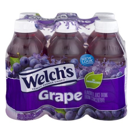 Welch's Grape Drink 10 oz bottle on a desk for on-the-go refreshment.