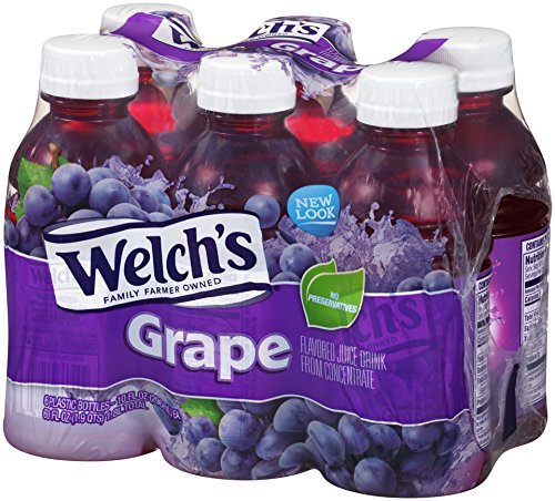 Welch's Grape Drink bottle on table with glass, ideal for sharing.