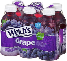 Welch's Grape Drink bottle on table with glass, ideal for sharing.