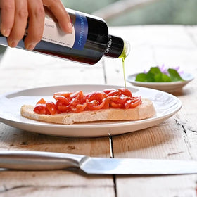 WellEatable Tuscan olive oil on olive branch, authentic freshness