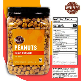 Wellsley Farms honey roasted peanuts close-up showing glossy glaze and sea salt crystals.