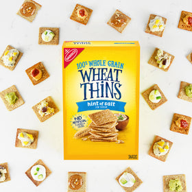 Wheat Thins Hint of Salt crackers on a cheese board for entertaining.